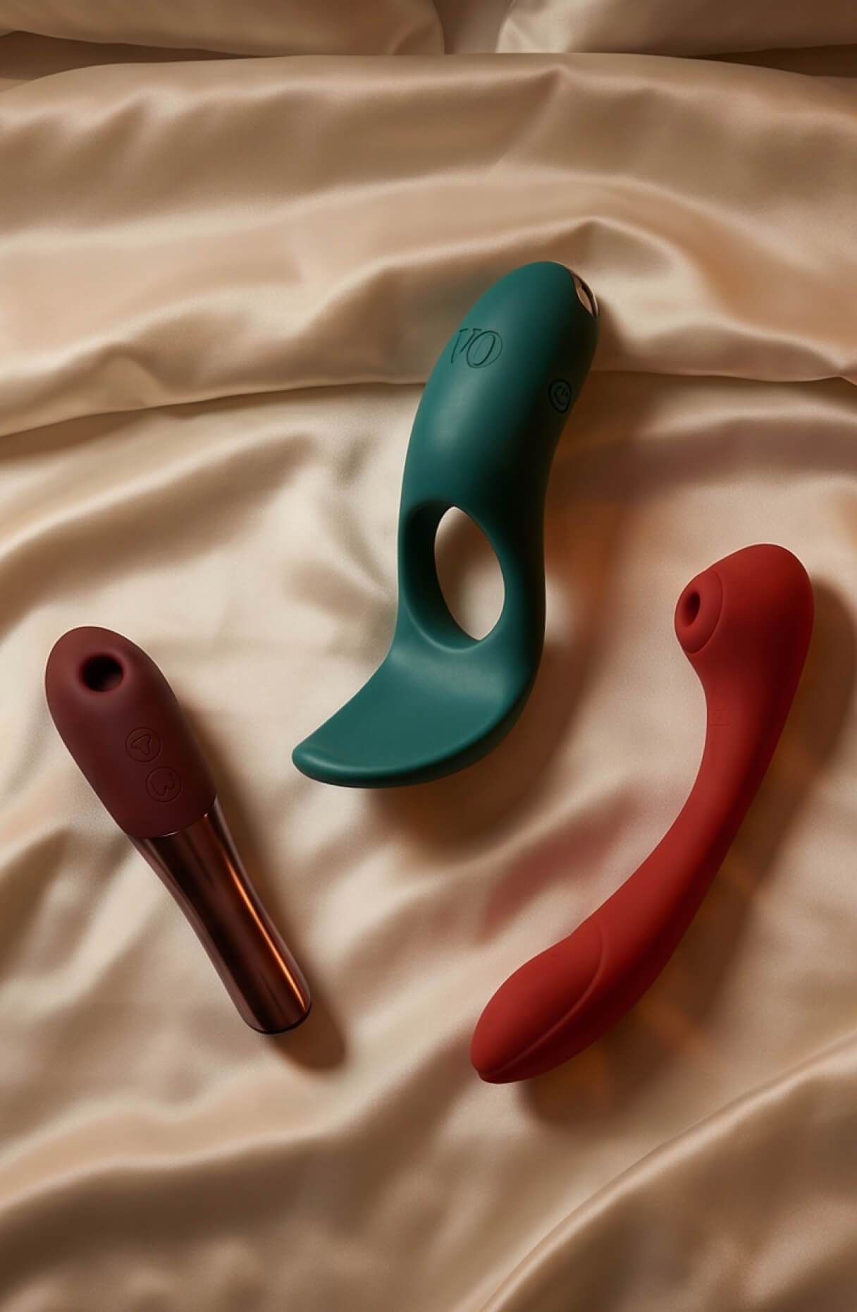 Couples' vibrators on silk sheets